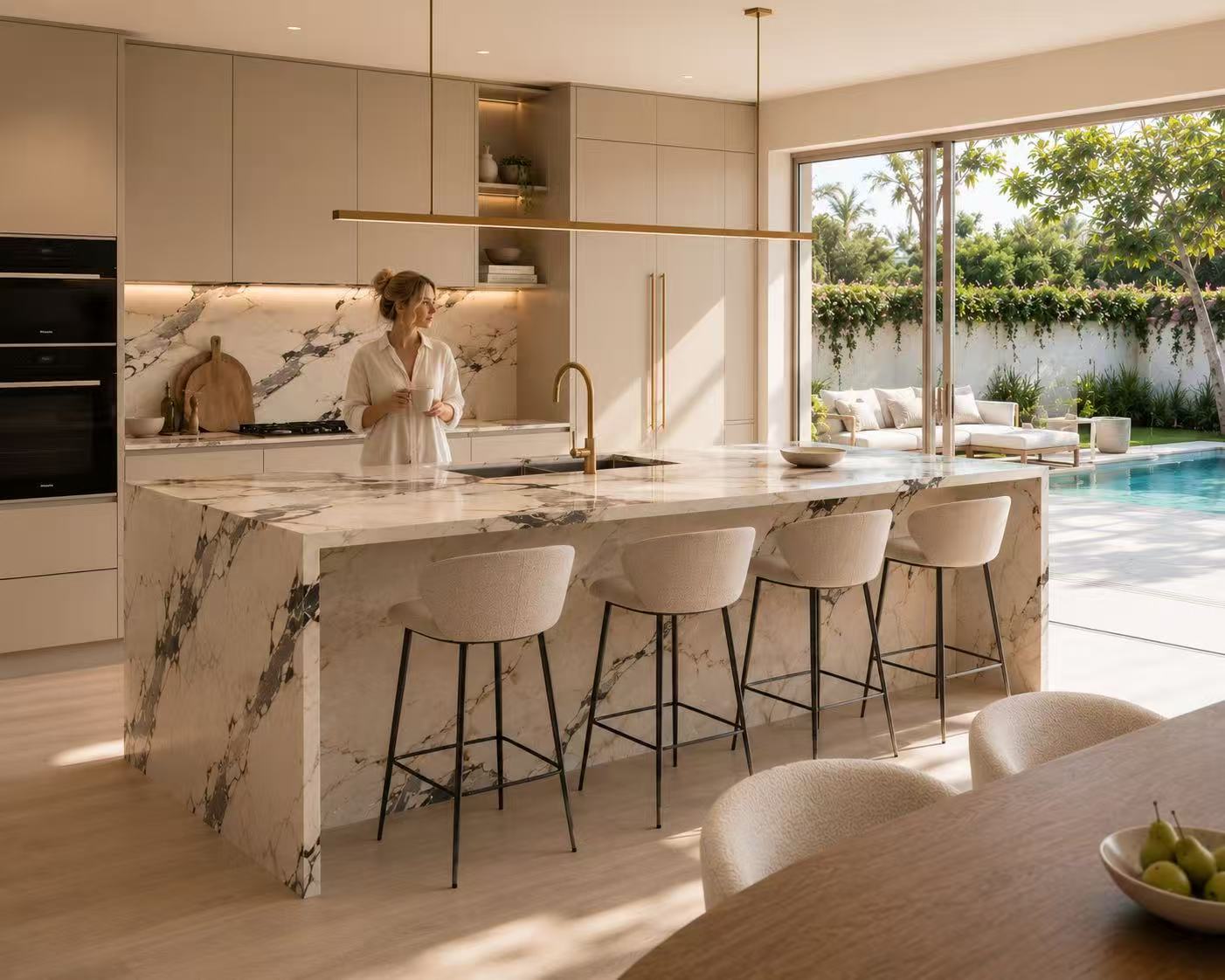 Warm kitchen interior with marble island and garden view