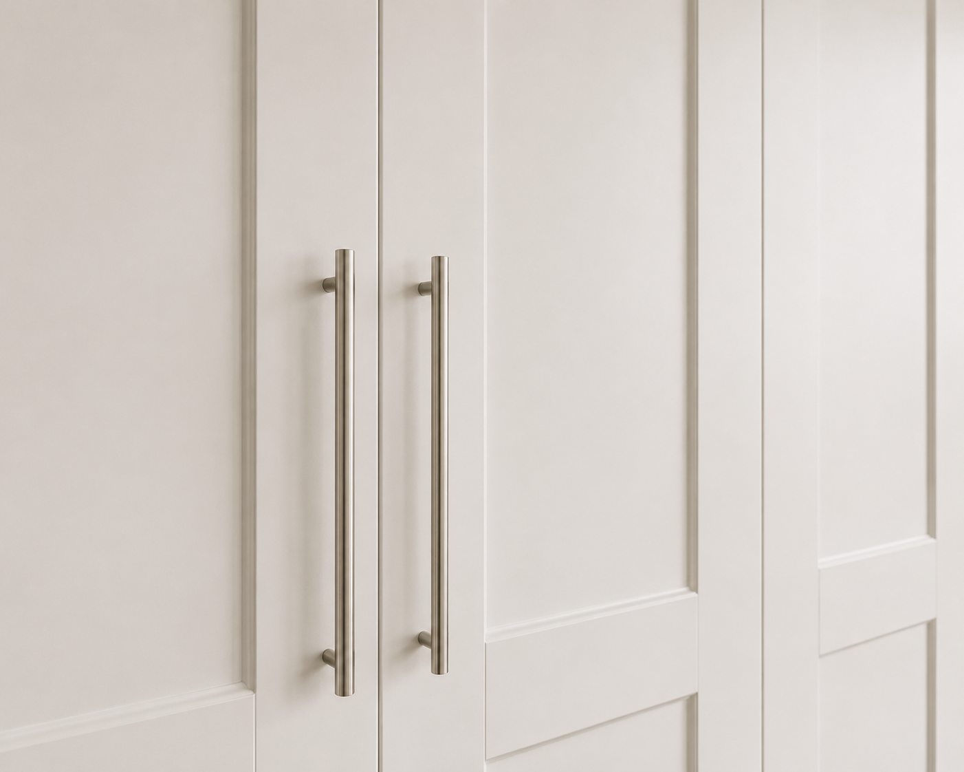 Close-up of the white bi-fold wardrobe doors and brushed metal handles